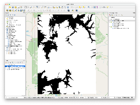 QGIS window showing the reclassified elevation raster in black and white over an OpenStreetMap basemap