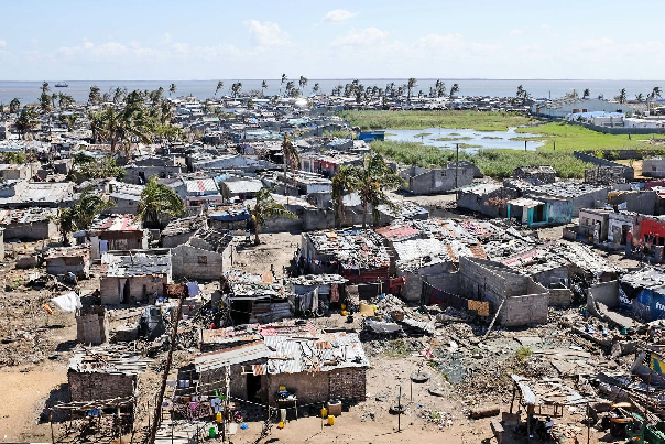Aerial view of Beira city with damaged rooftops and downed palm trees after Cyclone Idai