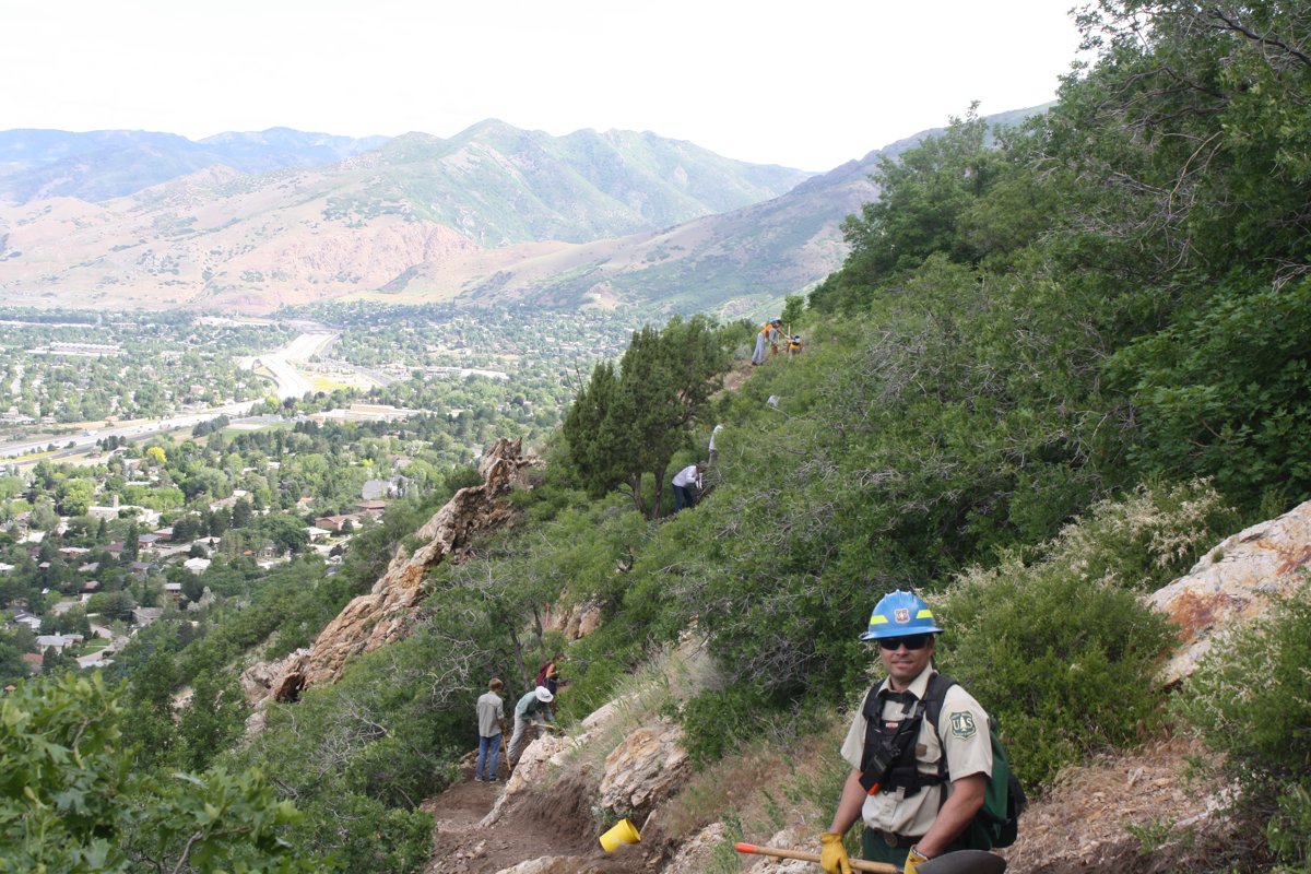 A trail crew member on the Mount Olympus trail above the Salt Lake Valley